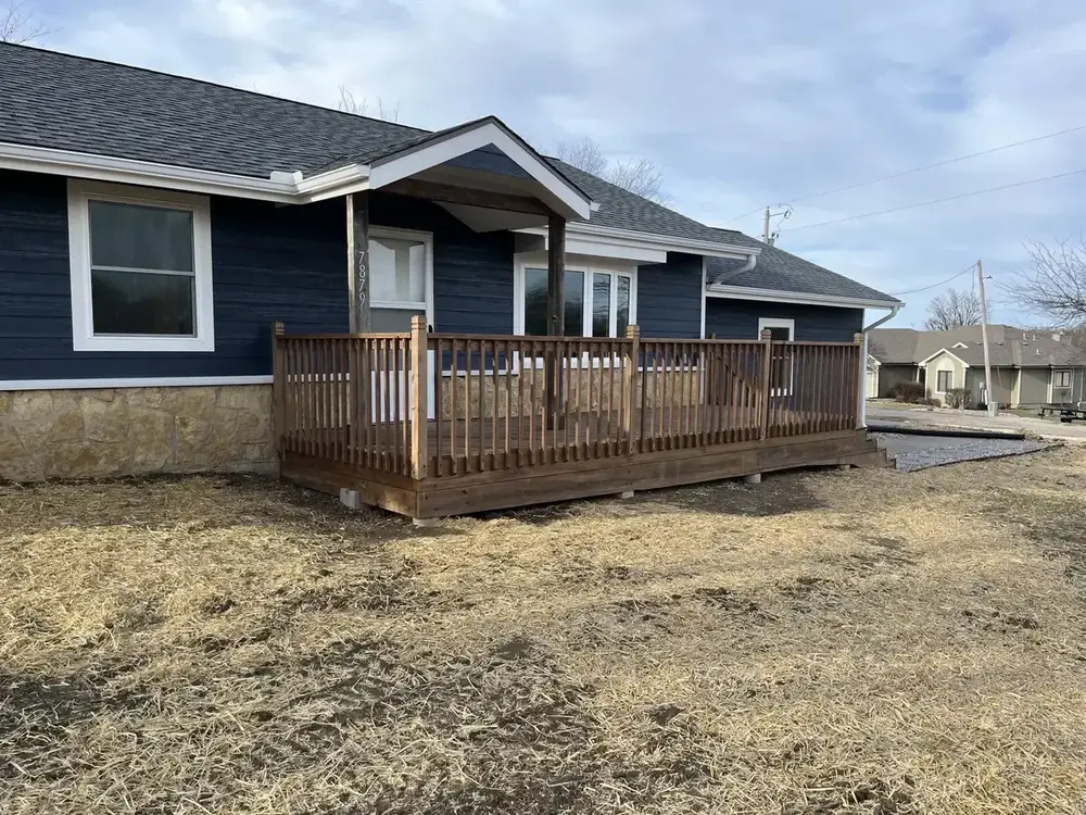 Completed deck project with railing by Kingdom Builders