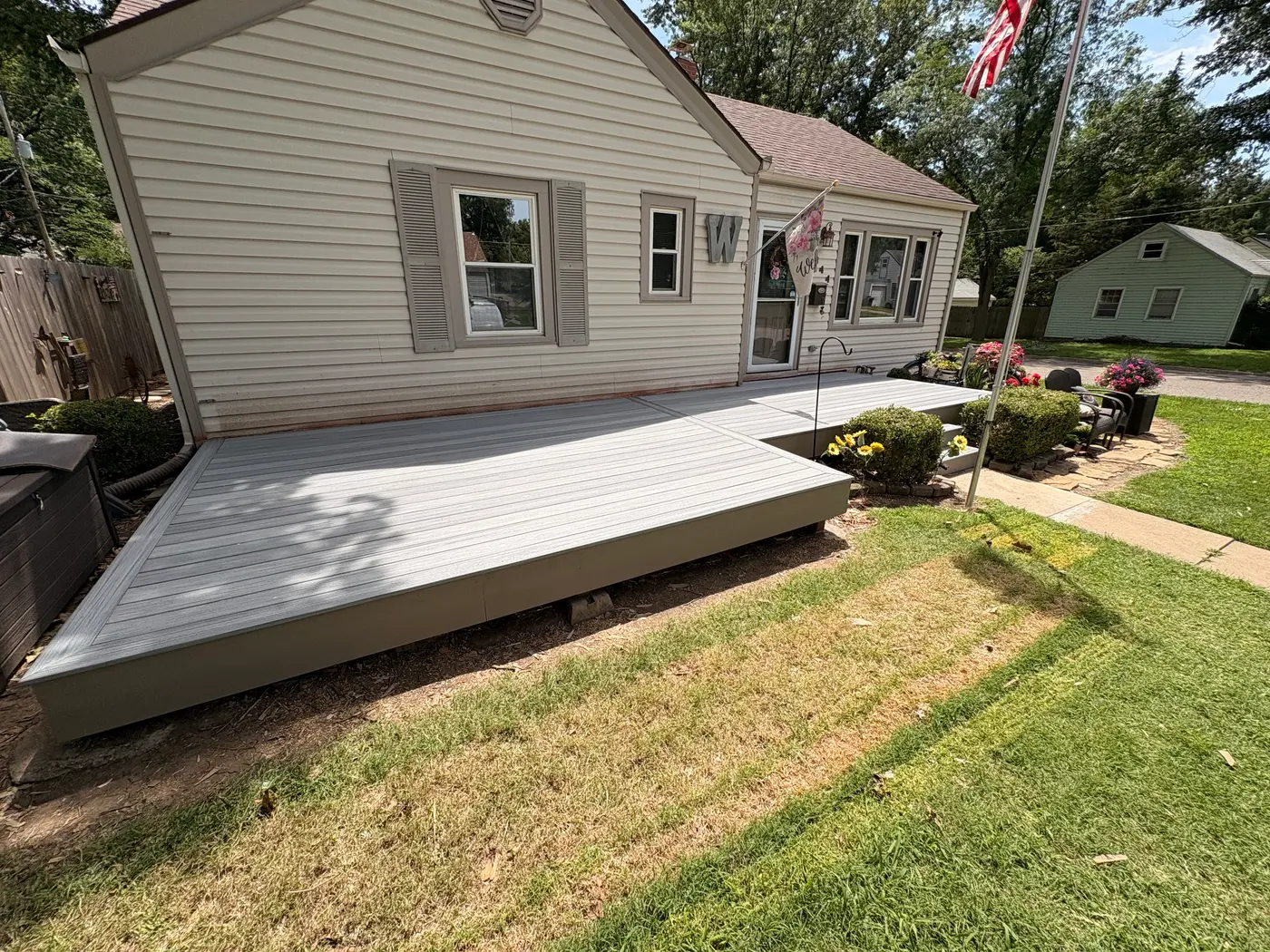 Low-profile grey composite deck built by Kingdom Builders Co. in Topeka, KS