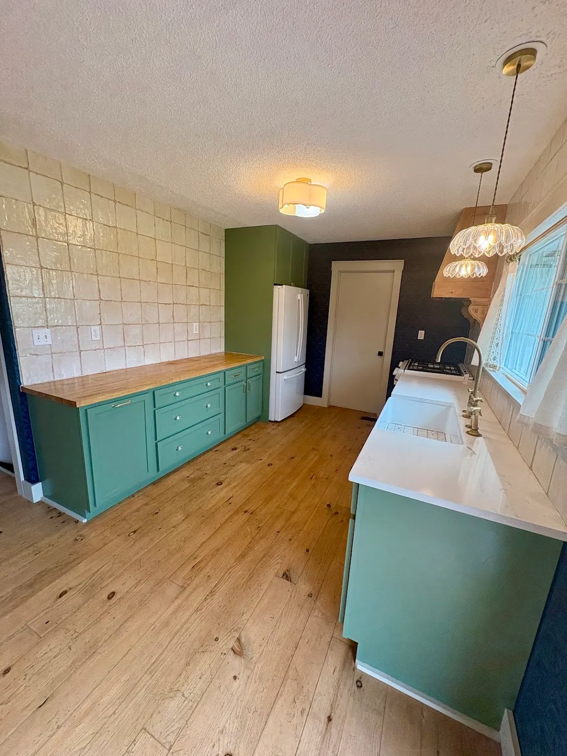 Refinished green kitchen cabinets with butcher block counters in a Topeka, KS home
