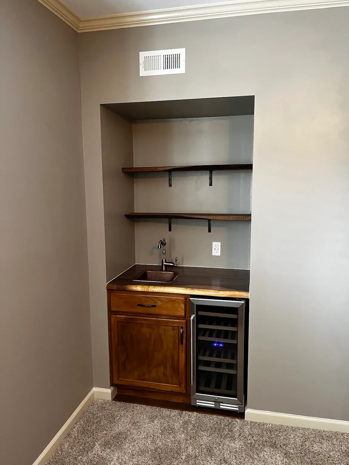 Custom stained cabinet and walnut shelving in a Topeka, KS wet bar build